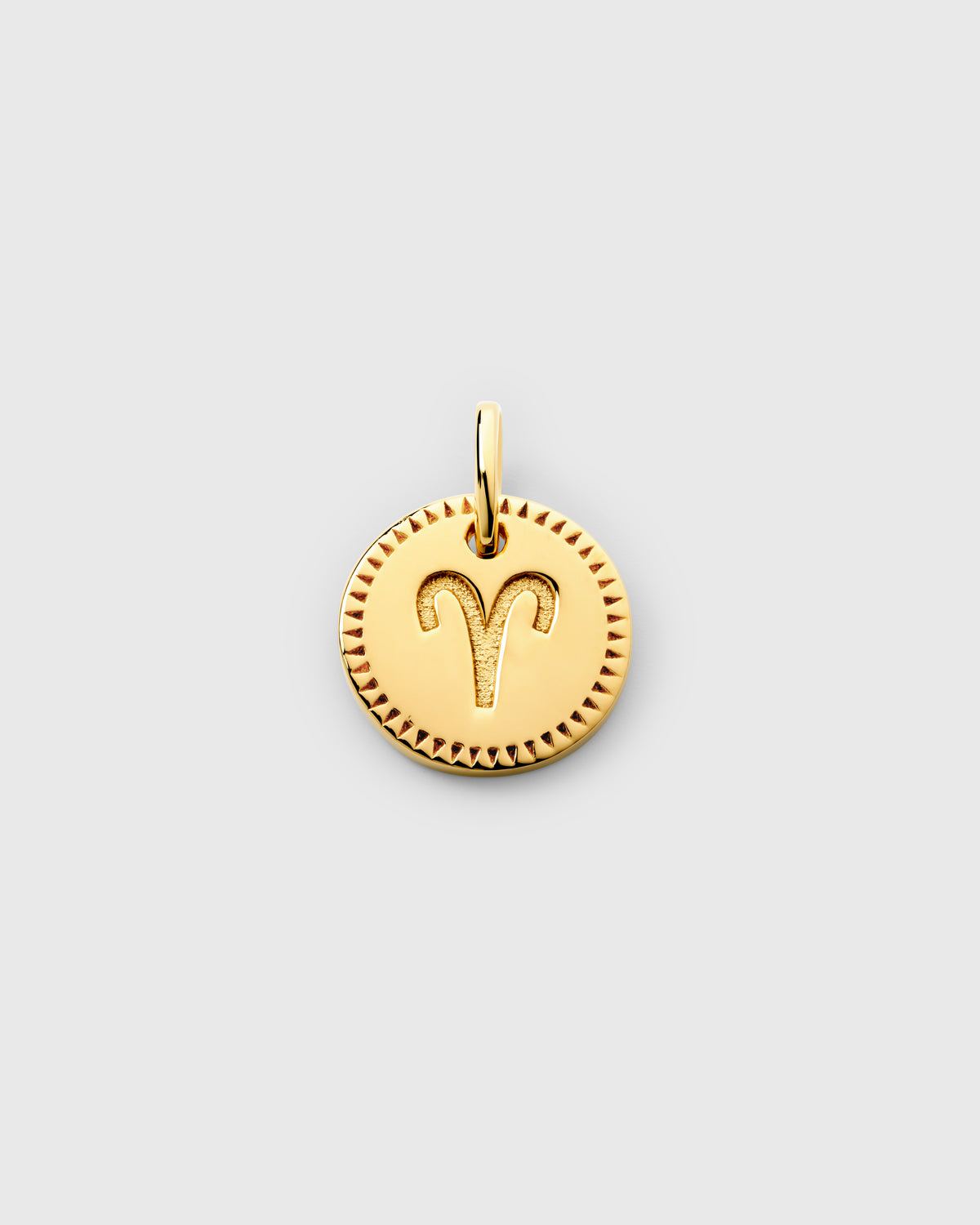 A product shot of the Beloved Zodie Pendant in gold, featuring the engraved zodiac symbol for Aries and a decorative border.