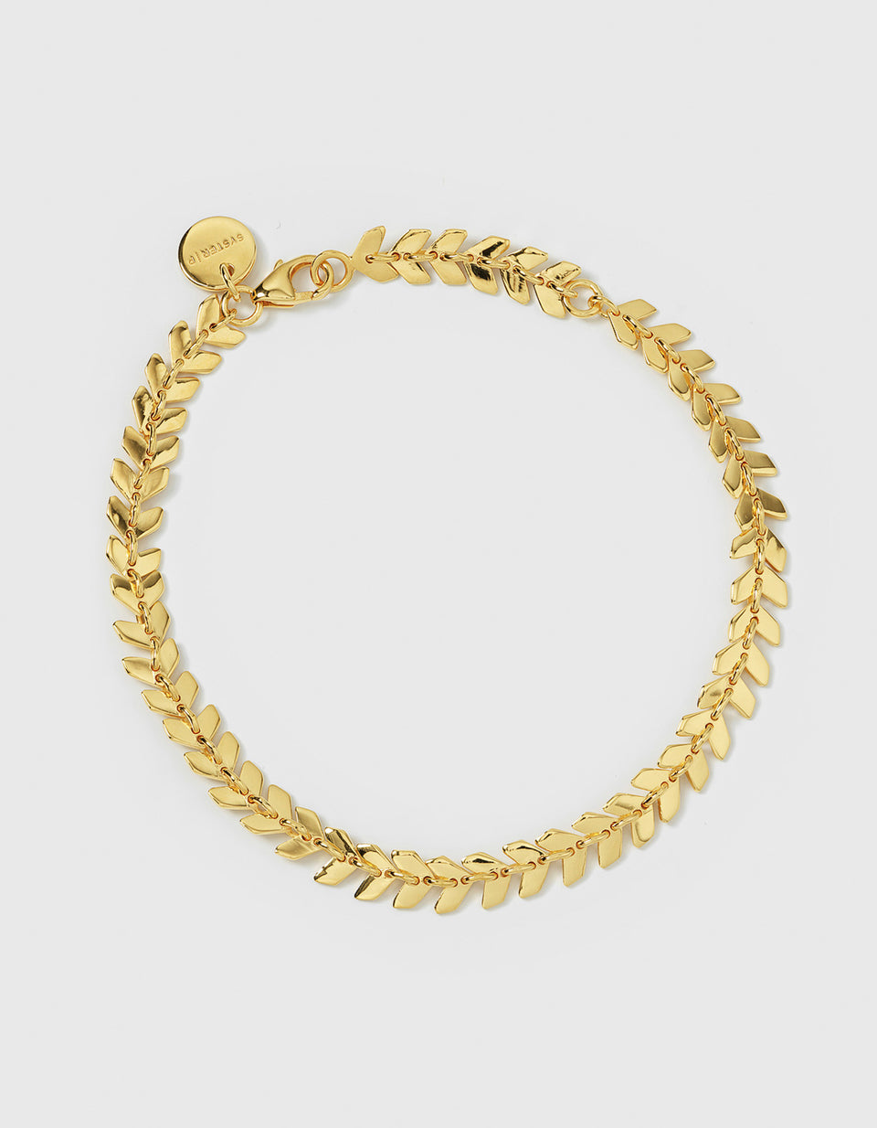 A product shot of the Layers Olivia Bracelet in gold, laid out in a circle to show its design of small, leaf-like links.