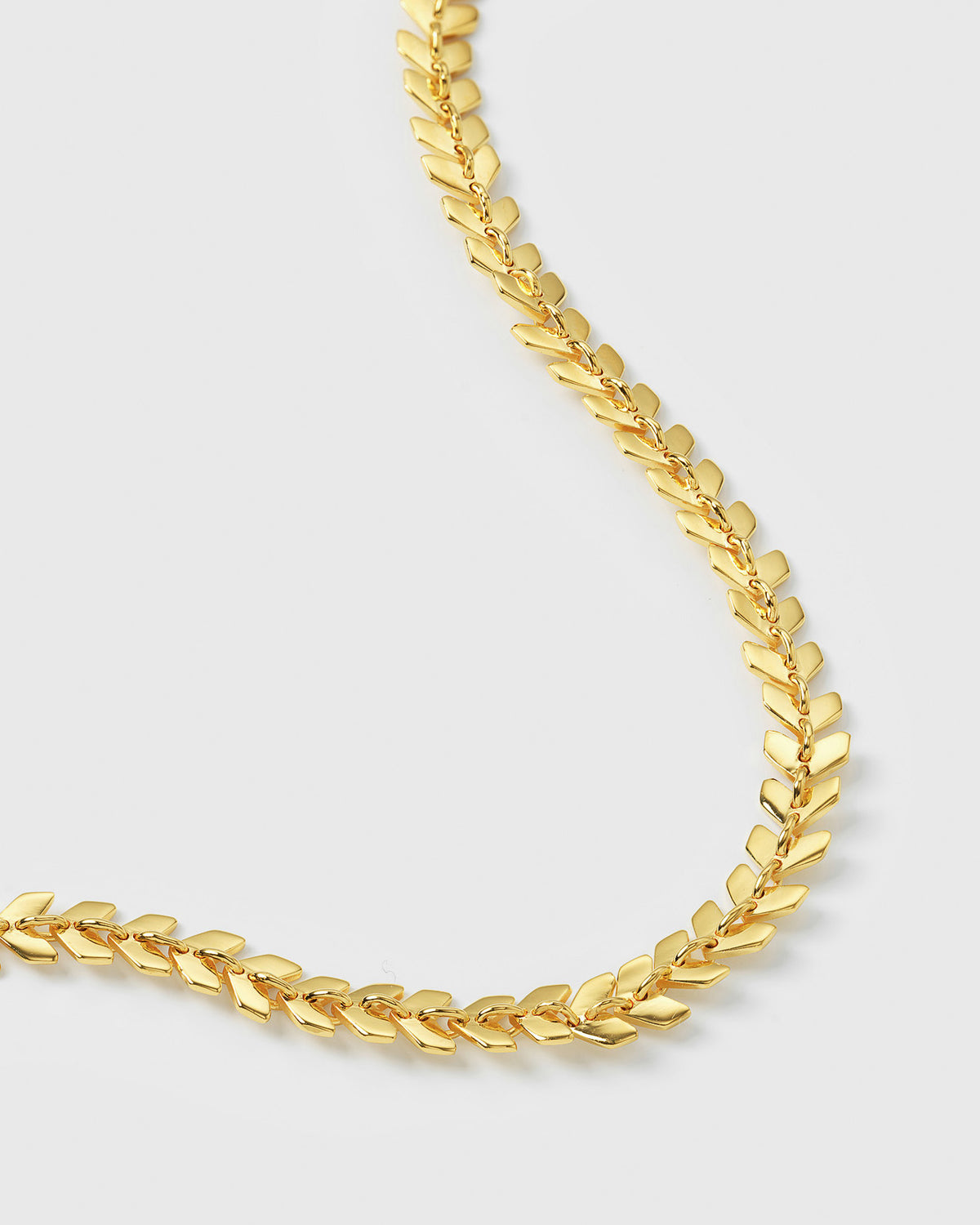 A close-up image of the gold Layers Olivia Bracelet, detailing its unique pattern of small, interconnected leaf-like links.