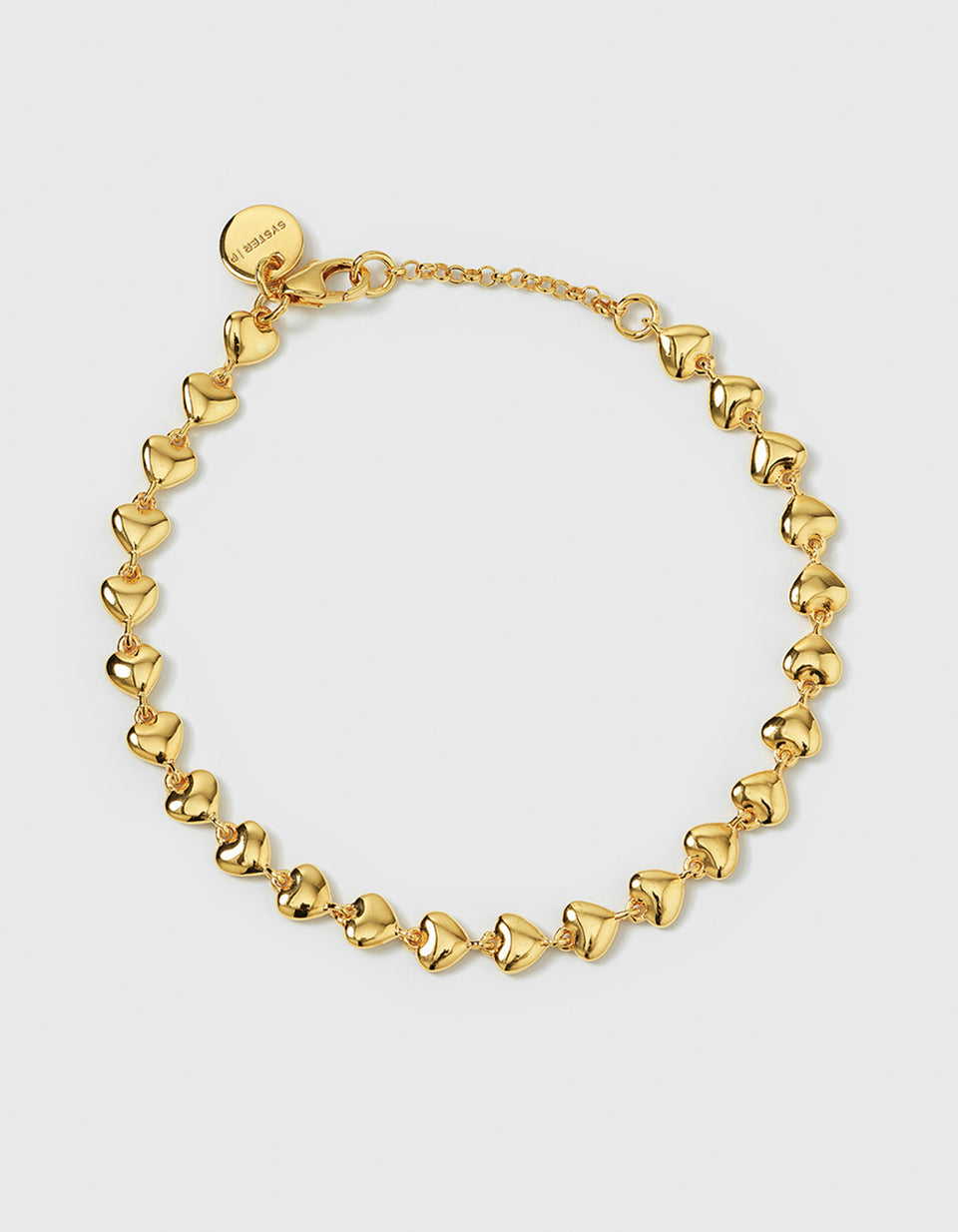 A product shot of the Darling Bracelet in gold, featuring a chain made entirely of small, interconnected polished hearts.