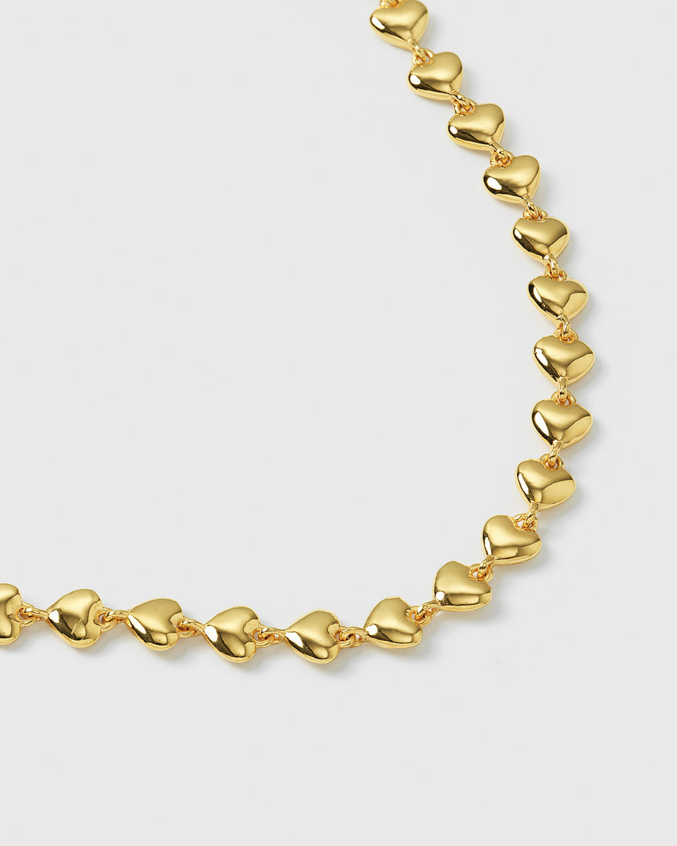 A product shot of the Darling Bracelet in gold, showing a close-up of its chain which is composed of small, linked hearts.