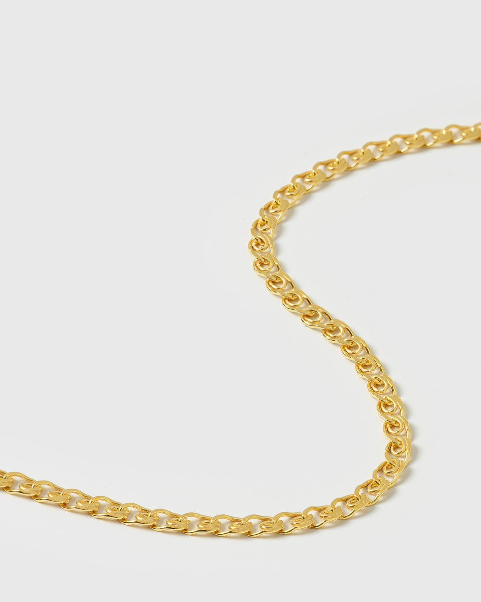 A close-up shot of the Sheer Love Bracelet in gold, displaying the intricate and unique patterned design of its chain links.