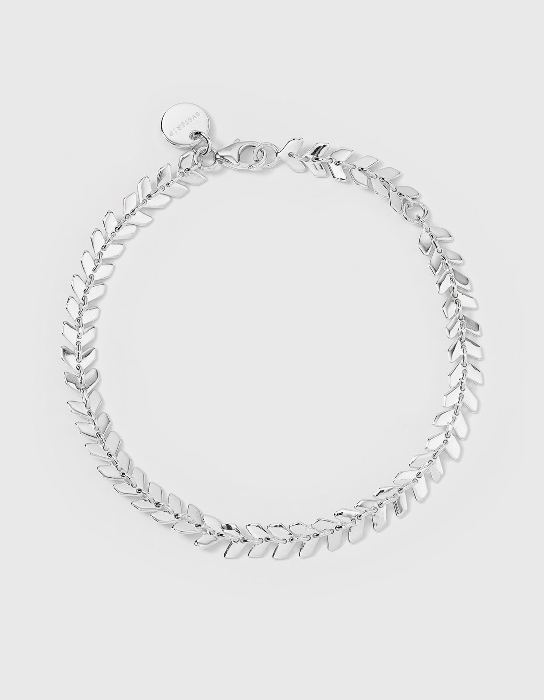 Studio shot of the Layers Olivia Bracelet in silver, laid out in a circle. The bracelet features a delicate pattern of small, interconnected leaf-like links.