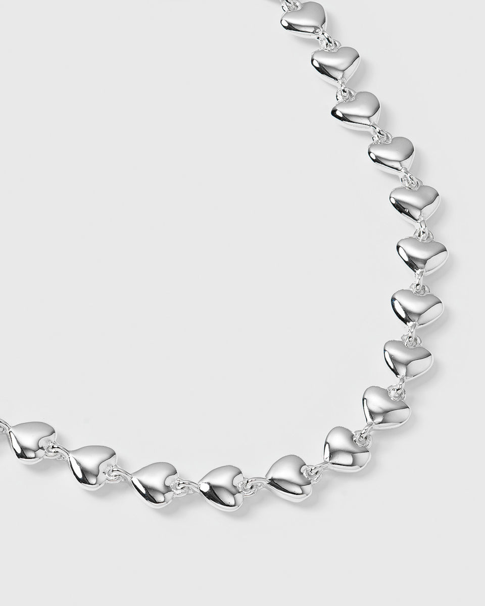 A close-up product shot of the Darling Bracelet in silver, showcasing its design as a continuous chain of interconnected puffy hearts.