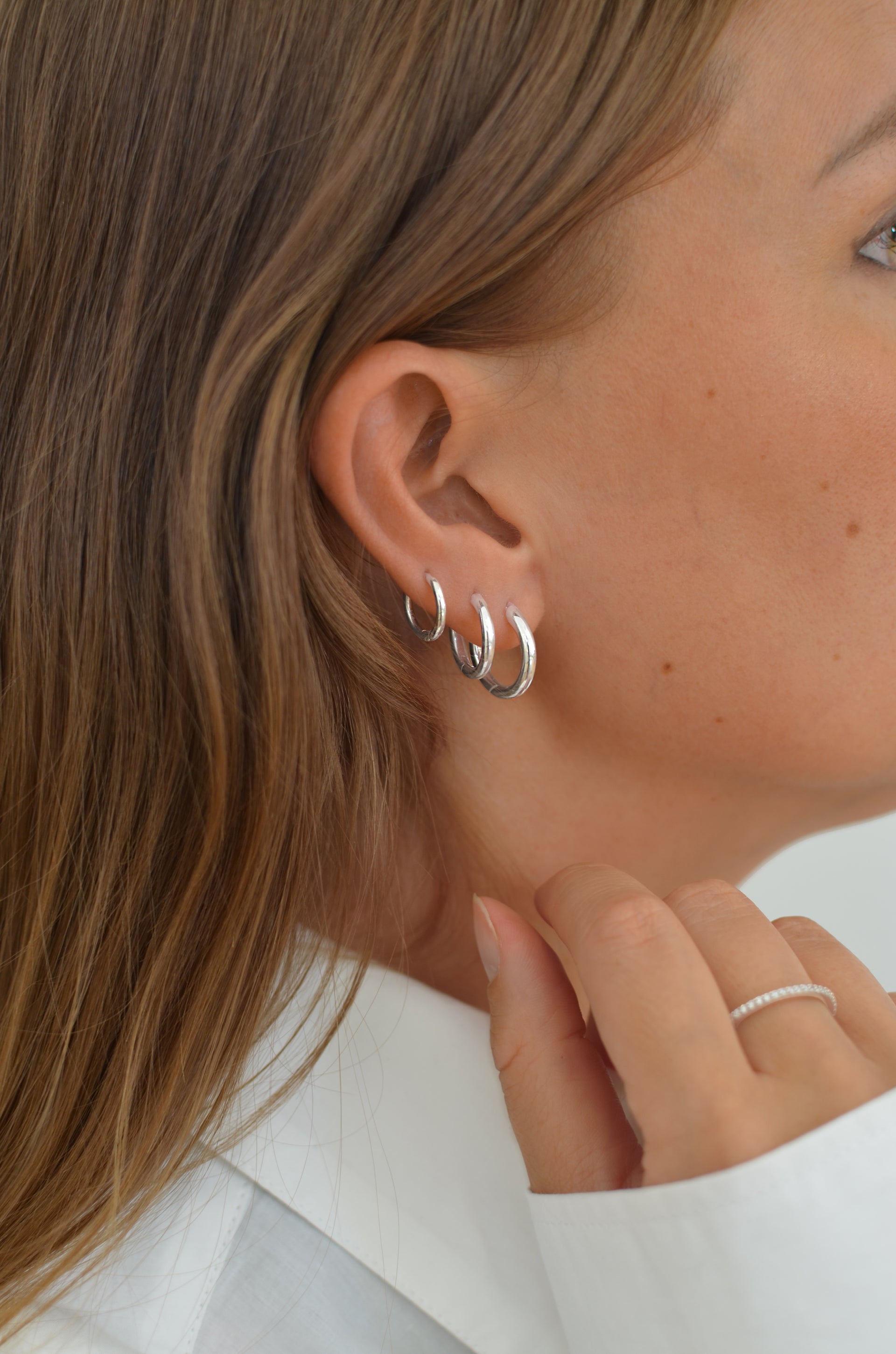 Three silver hoops in three different sizes