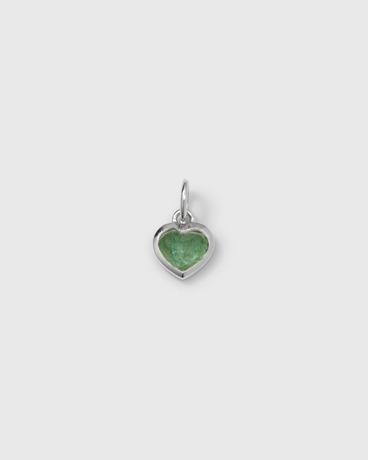 A product shot of the Beloved Heart Pendant in silver, featuring a heart-shaped setting with a central green aventurine stone.