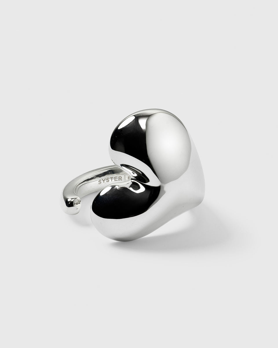 A product shot of the Bolded Heart Ring in silver, showcasing its large, polished, heart-shaped design.
