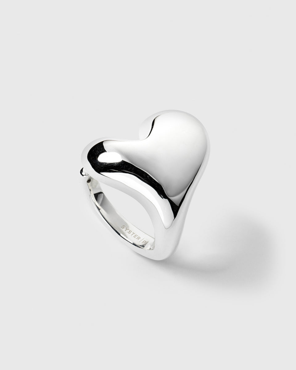 A product shot of the Bolded Heart Ring in silver, highlighting its chunky and smoothly polished heart-shaped design.