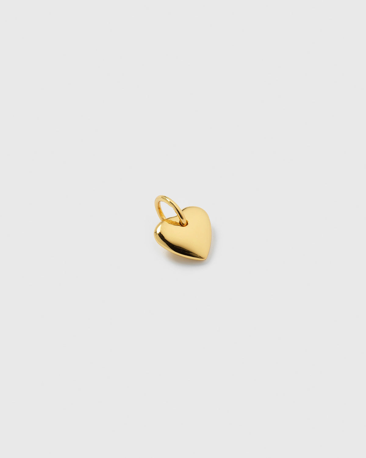 A product shot of the Beloved Heart Pendant in gold, showcasing its simple and smooth heart-shaped design.