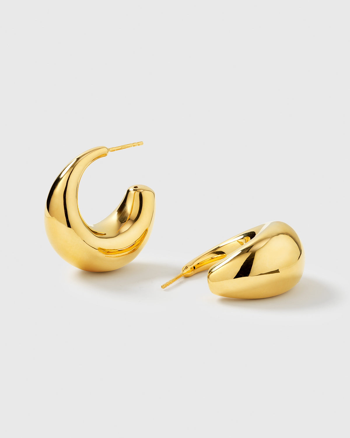 A product shot of the Bolded Earrings in gold, arranged to display their unique, chunky drop shape and polished finish.