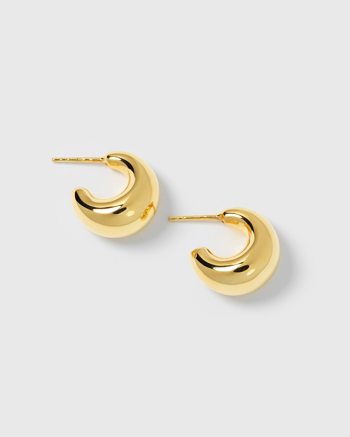 A product shot of the Bolded Little Sis Earrings in gold, showcasing their chunky, crescent-shaped design.