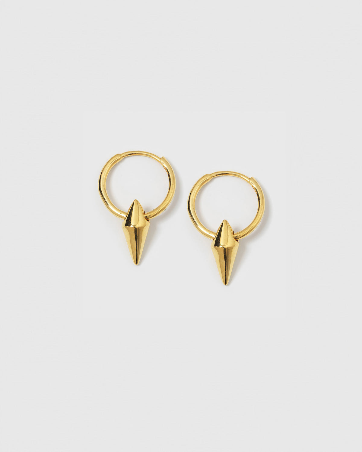 A product shot of the Harvey Small Spike Hoops in gold, featuring a pair of small hoops each adorned with a pointed spike charm.