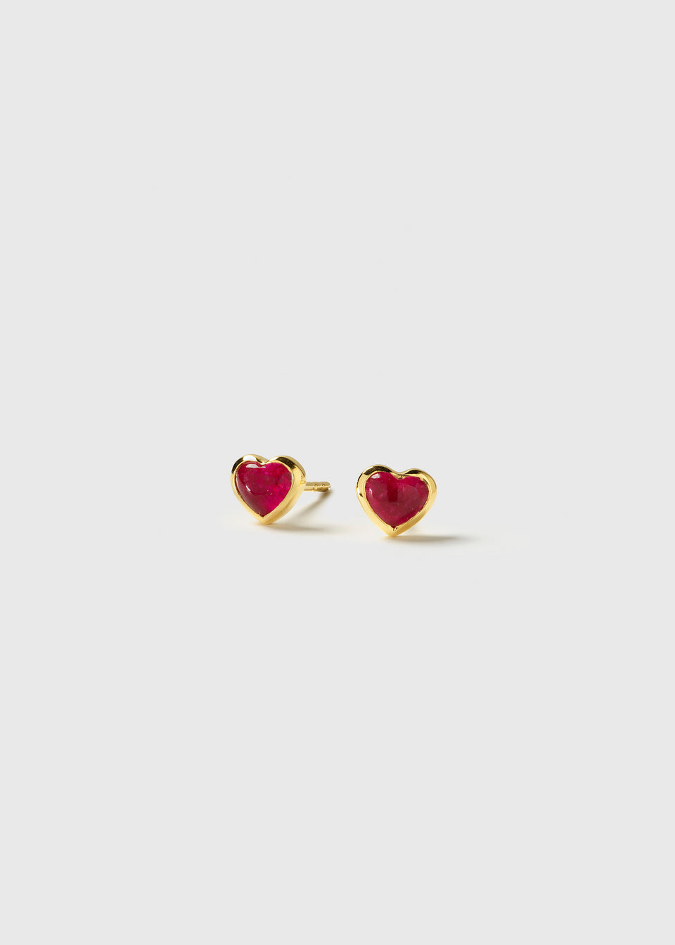 A pair of La La Love stud earrings featuring heart-shaped pink quartz stones set in polished gold-plated frames.
