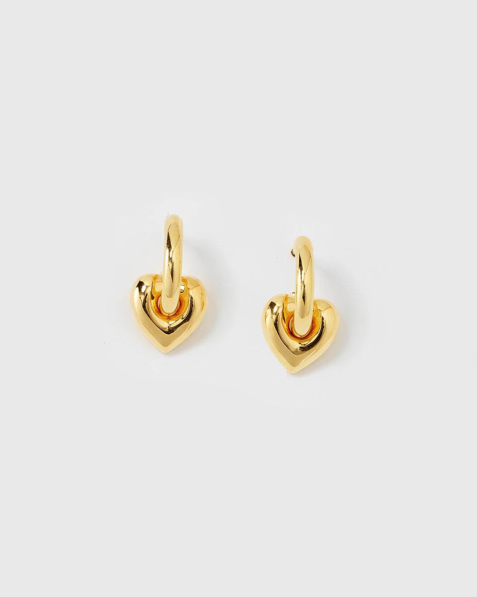 A pair of the La La Love Fat Heart Earrings in gold, featuring a chunky heart charm hanging from a small hoop.