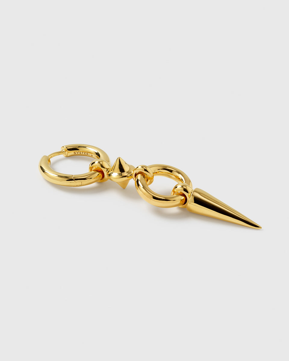 A product shot of the gold Juno Long Single Earring, laid out to display its design featuring a chunky hoop, a small spike, an interlocking link, and a long dangling spike.
