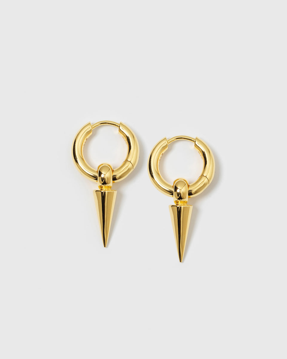 A product shot of the Juno Hoops in gold, featuring a pair of thick hoop earrings, each adorned with a dangling spike charm.