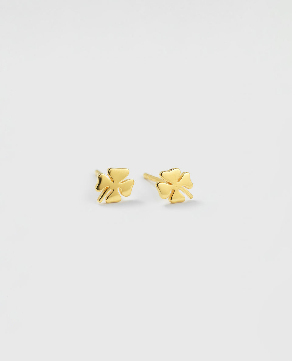 A product shot of the Bring Me Luck Studs in gold, showcasing the pair of stud earrings shaped like four-leaf clovers.