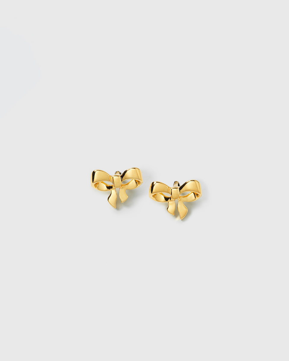 A product shot of the Rosie Mini Studs Gold, showcasing the pair of delicate, bow-shaped earrings.