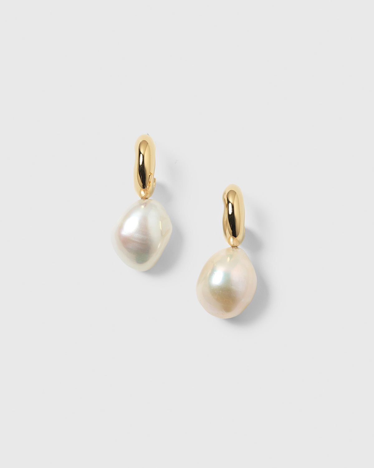 A pair of Paxton gold earrings, each with a large baroque freshwater pearl drop.