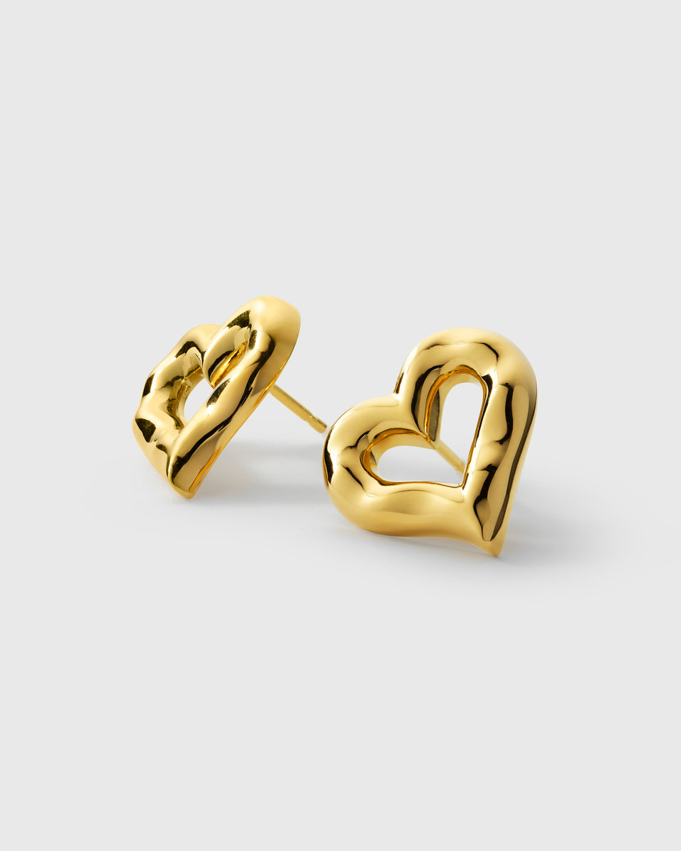 A product shot of the Puff Heart Earrings in gold, highlighting their chunky and organic heart shape.