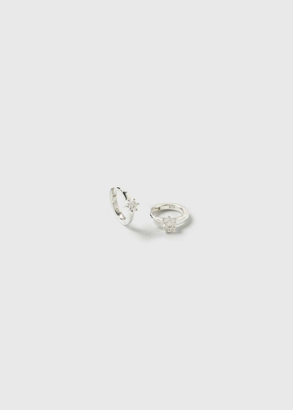 A product shot of the Mini Princess Hoops in silver, featuring a pair of small hoop earrings each set with a single crystal.