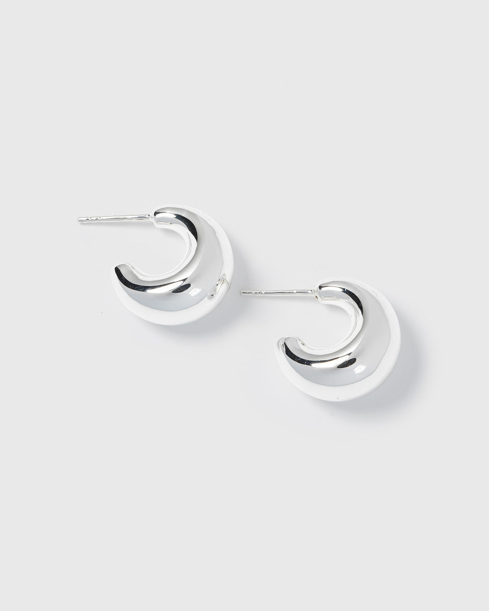 A product shot of the Bolded Little Sis Earrings in silver, showcasing their chunky and polished crescent hoop design.