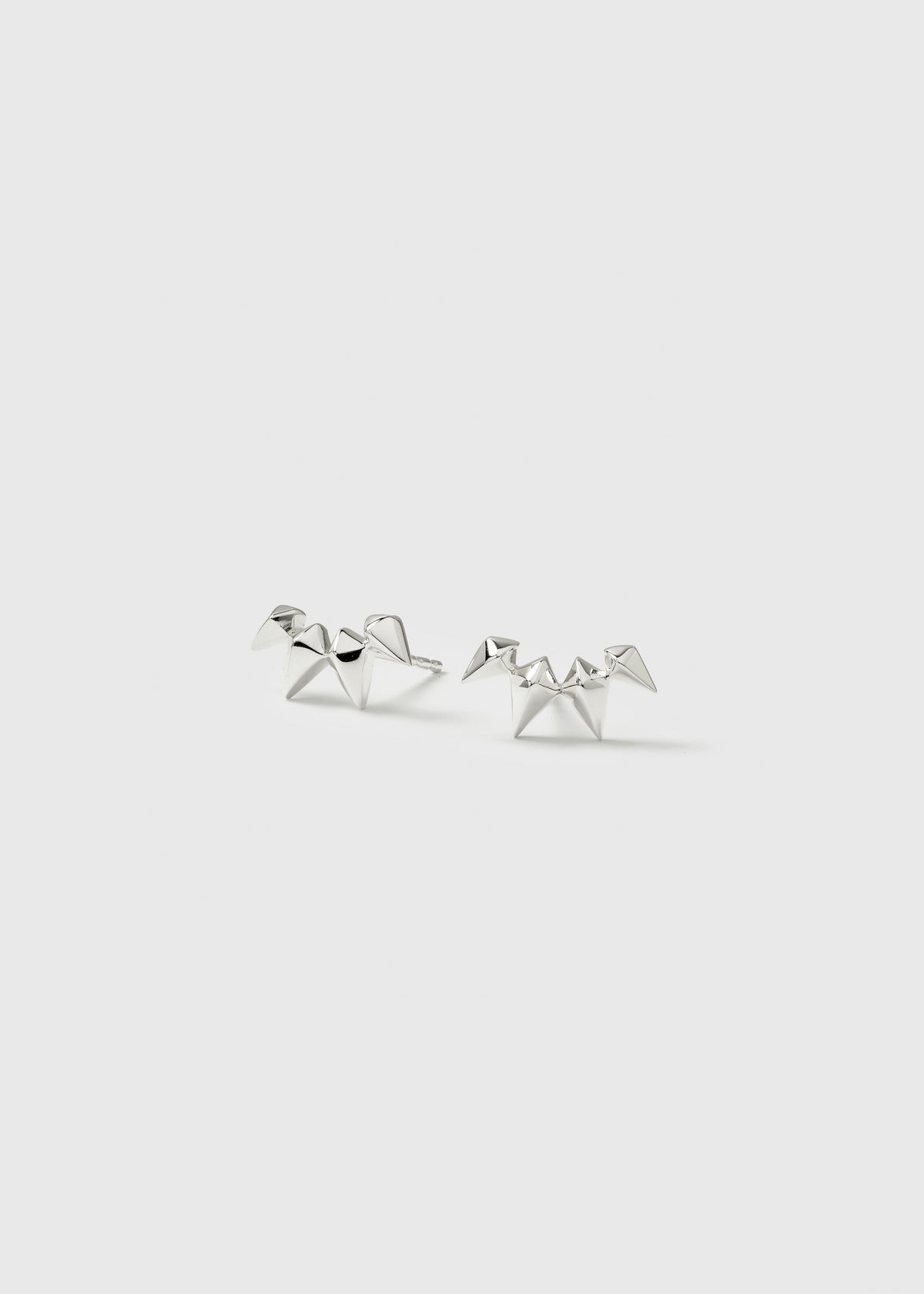 A product shot of the Uma Climber Earrings in silver, featuring their distinctive design of small, sharp spikes arranged in a climber style.