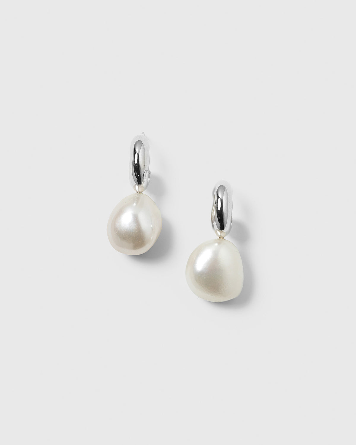 A pair of Paxton silver earrings with baroque freshwater pearls, handcrafted from 100% recycled sterling silver.