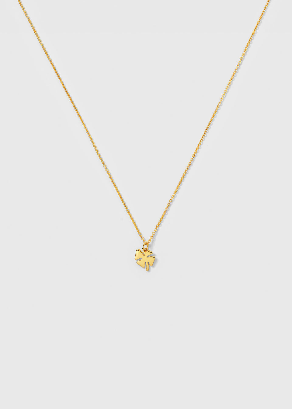 A product shot of the Bring Me Luck Necklace in gold, featuring a thin chain and a polished four-leaf clover pendant.