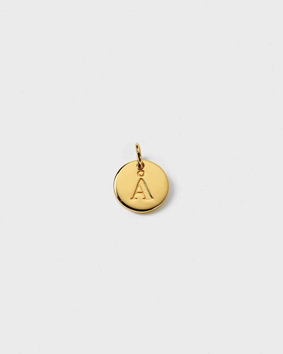 A product shot of the Beloved Mini Letter Gold charm, showing the small, round pendant with the initial 'A' engraved on it.