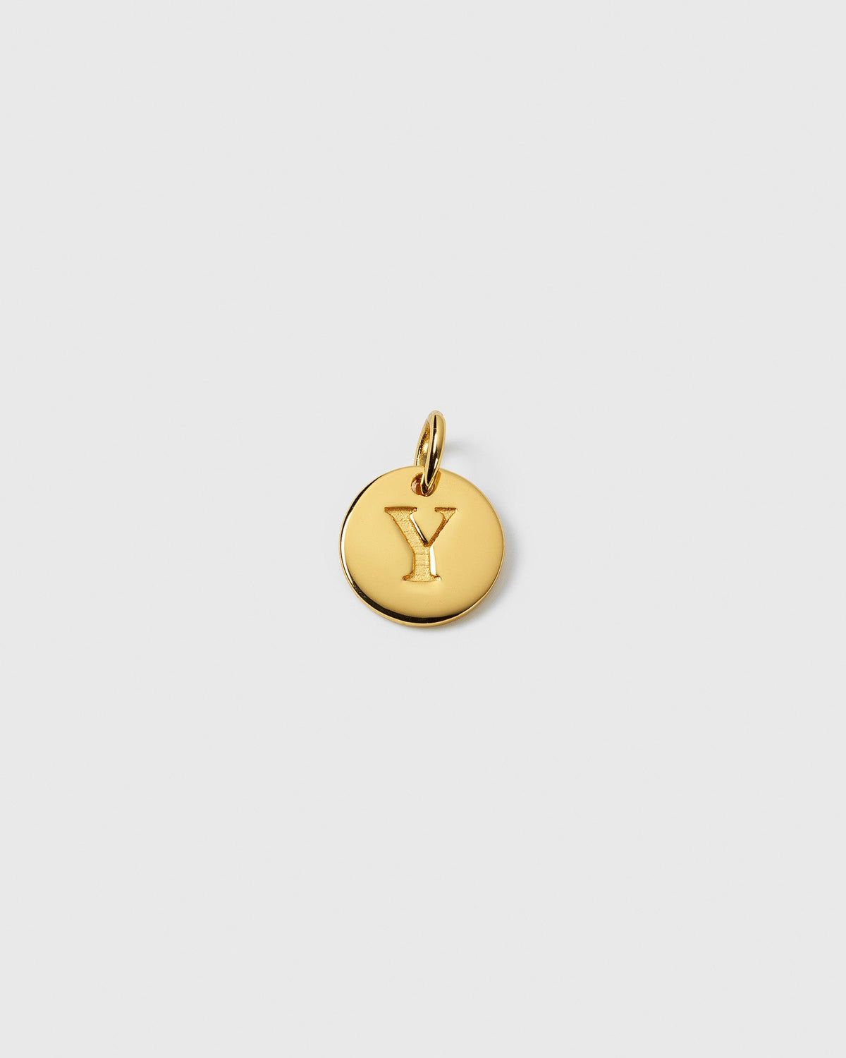 A product shot of the Beloved Mini Letter Gold pendant, featuring a round gold charm engraved with the letter 'Y'.