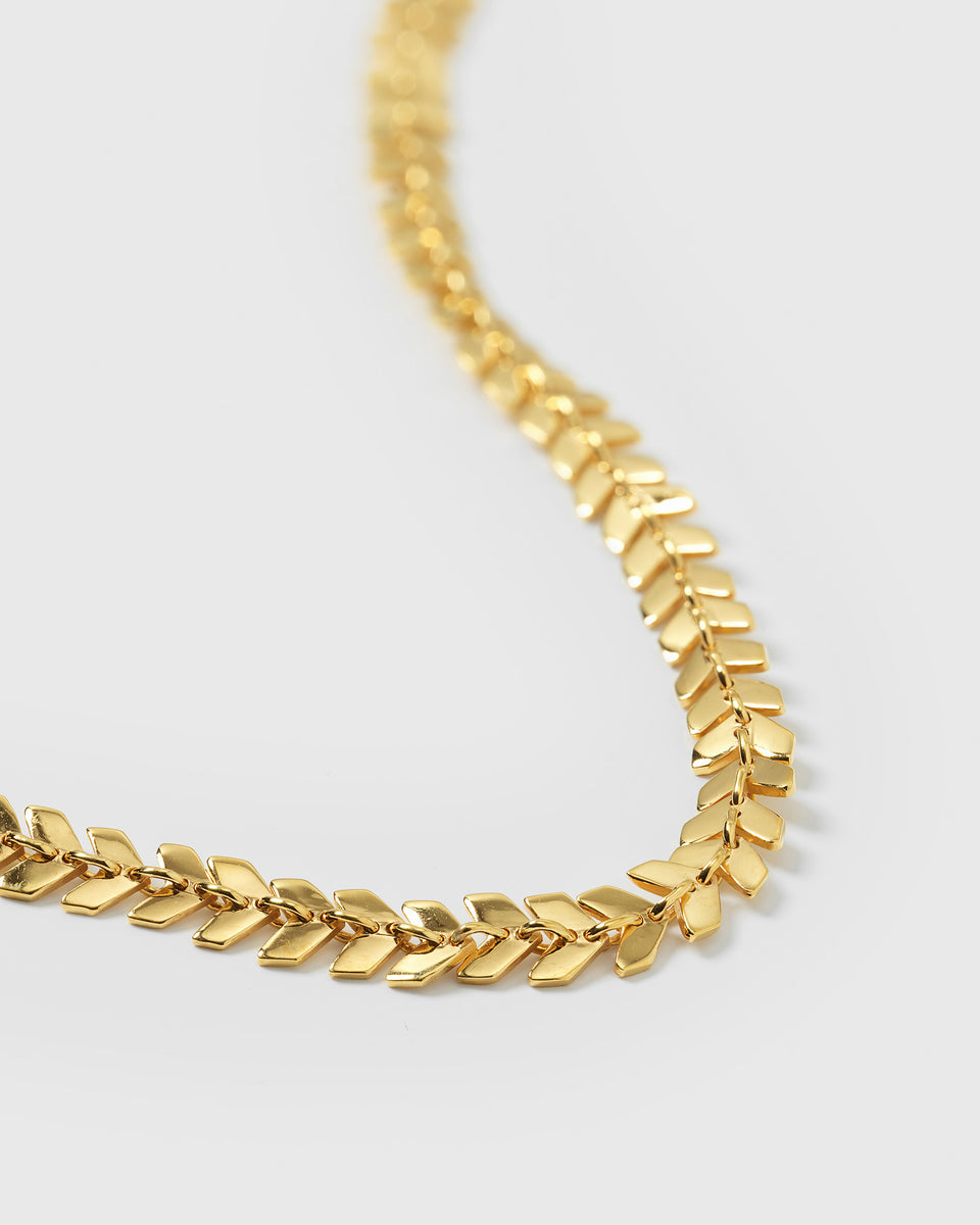 A detailed close-up of the Layers Olivia Necklace in gold, showing the intricate pattern of its chain composed of small, interlocking leaf-shaped links.