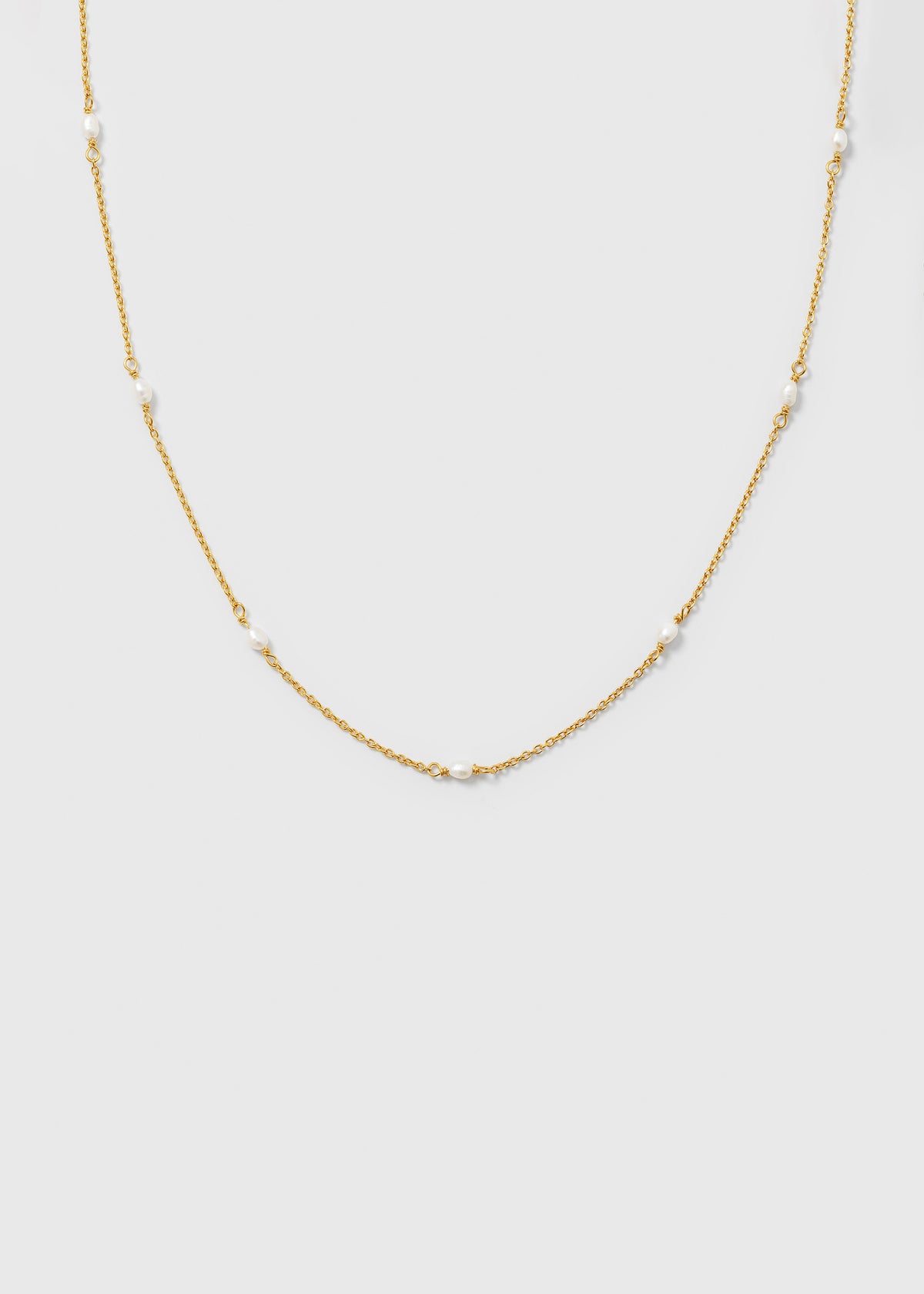 A product shot of the Treasure Multi Pearl Necklace Gold, featuring a fine gold chain adorned with small, evenly spaced freshwater pearls.