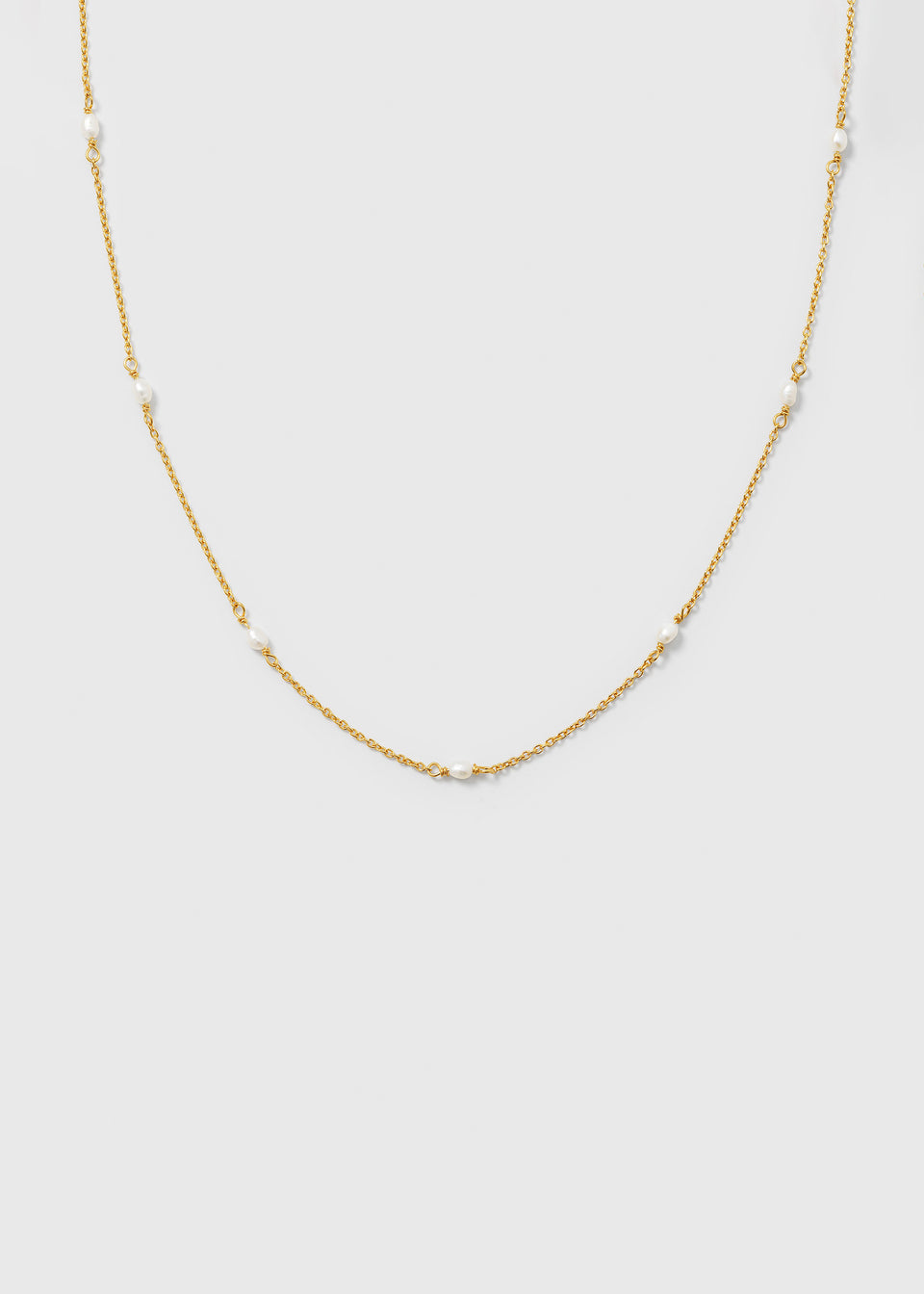 A product shot of the Treasure Multi Pearl Necklace Gold, featuring a fine gold chain adorned with small, evenly spaced freshwater pearls.