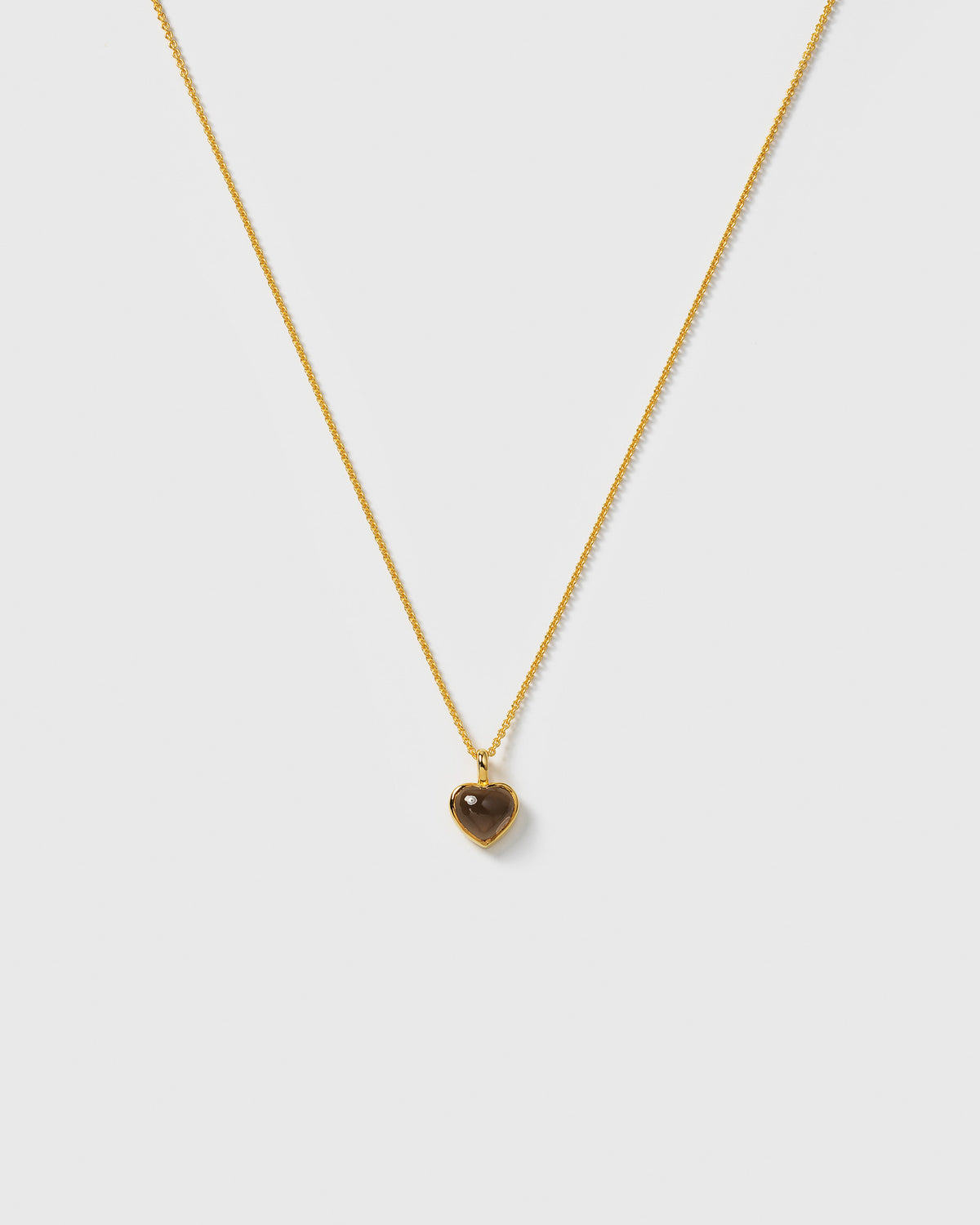La La Love Necklace with a delicate gold chain and a heart-shaped pendant with a smokey quartz stone.