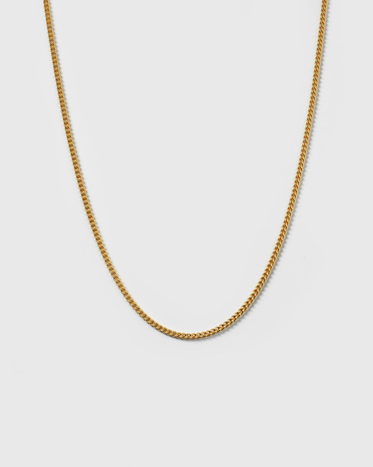 A product shot of the Beloved Short Curb Chain in gold, displayed in a U-shape to showcase its classic curb link design.