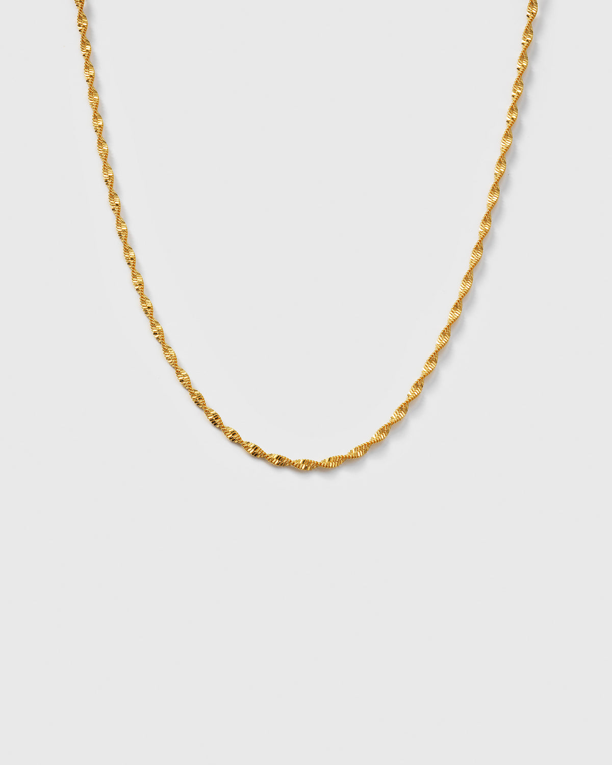A product shot of the Herringbone Twisted Necklace in gold, showcasing its intricate twisted chain.