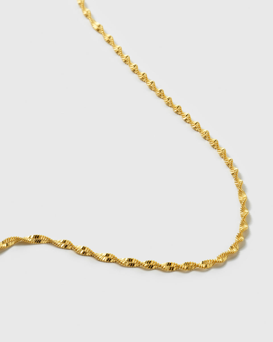 A close-up image of the Herringbone Twisted Necklace in gold, showing the intricate detail of its twisted, textured chain.