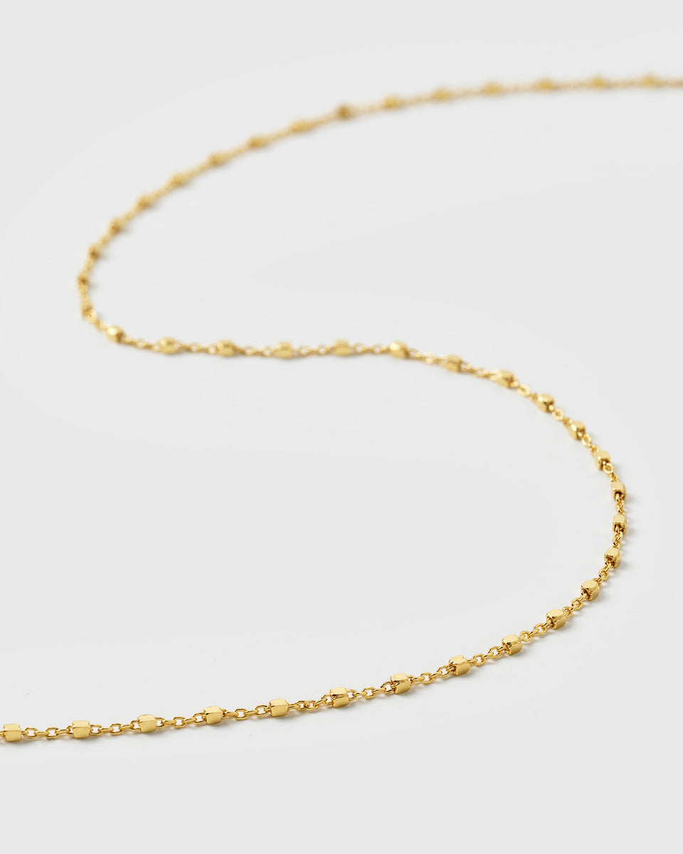 A product shot of the Sheer Station Necklace in gold, featuring its delicate chain design with small, evenly spaced dots.