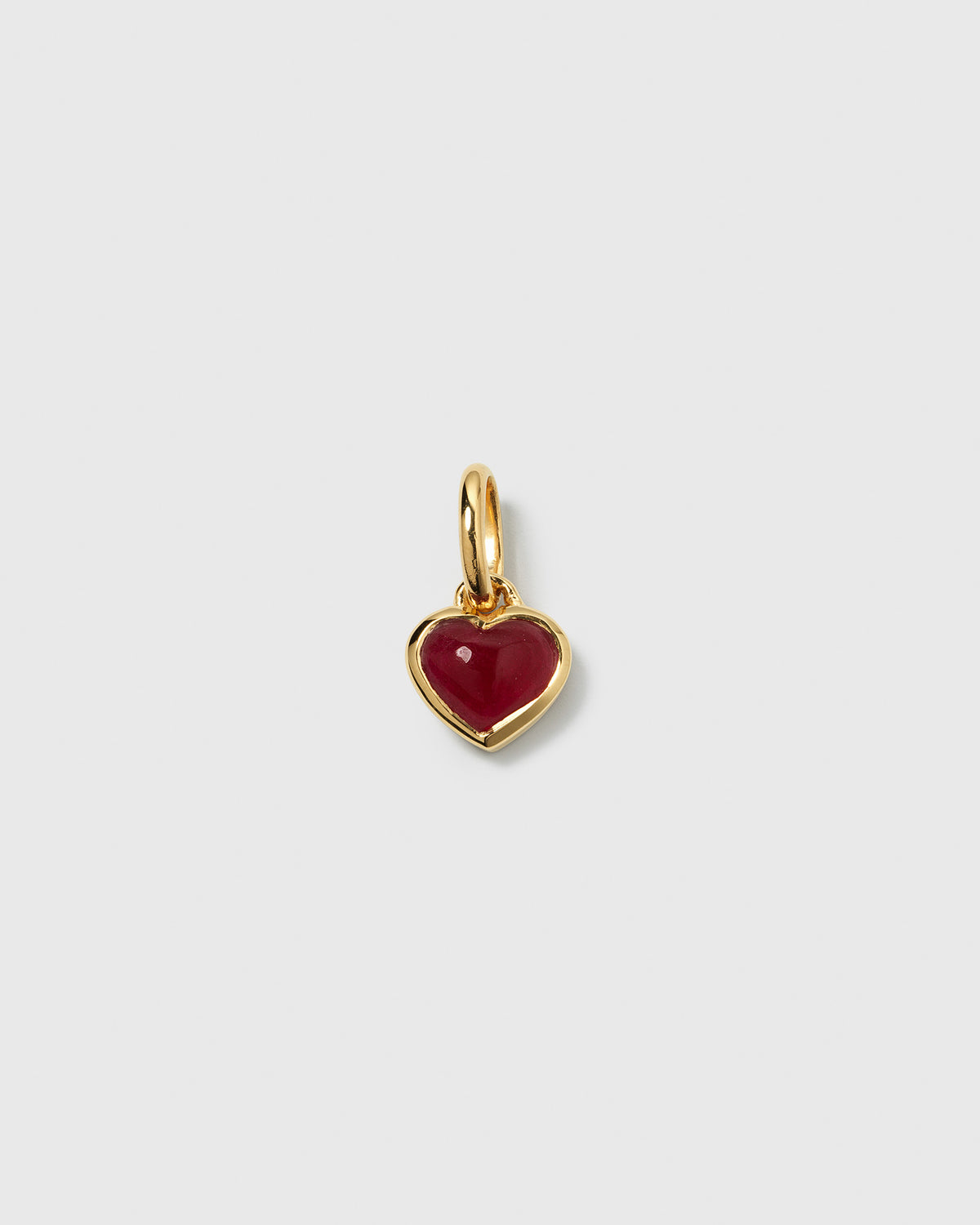 A product shot of the Beloved Heart Pendant in gold, featuring a heart-shaped pink quartz stone set within a polished, gold-plated frame.