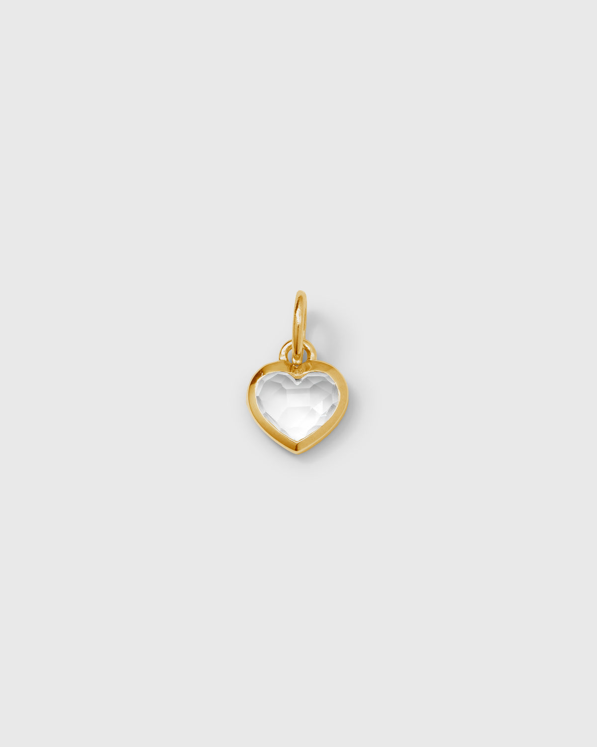 A product shot of the Beloved Heart Pendant Gold, featuring a faceted, heart-shaped crystal set in a gold-plated frame.