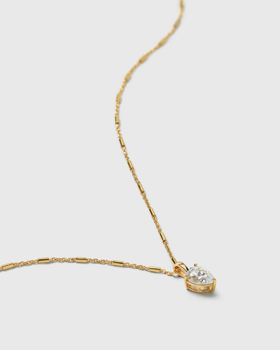 A product shot of the Katie Necklace in gold, featuring its unique chain and a drop-shaped pendant with a sparkling cubic zirconia.