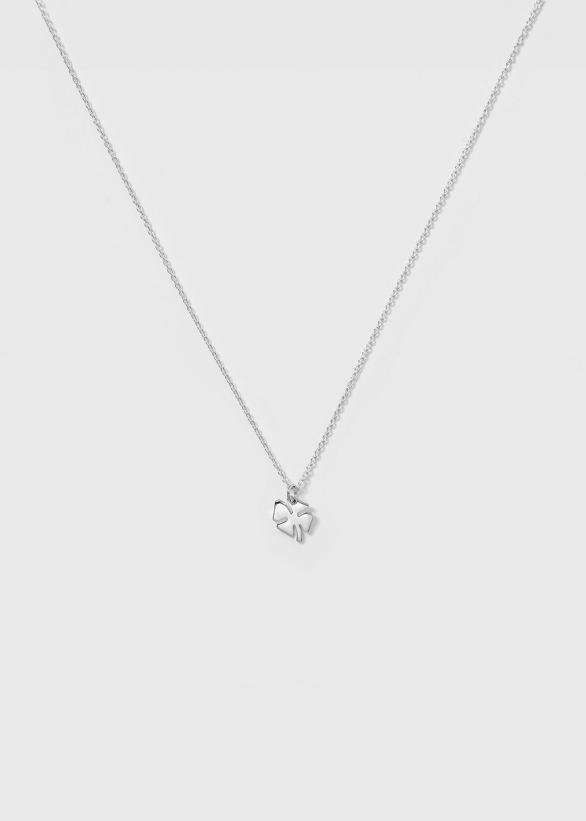 A product shot of the Bring Me Luck Necklace in silver, featuring a fine chain and a small four-leaf clover pendant.
