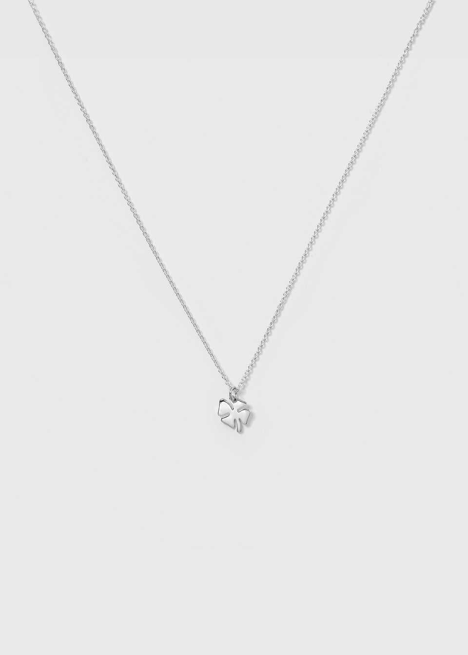 A product shot of the Bring Me Luck Necklace in silver, featuring a fine chain and a small four-leaf clover pendant.