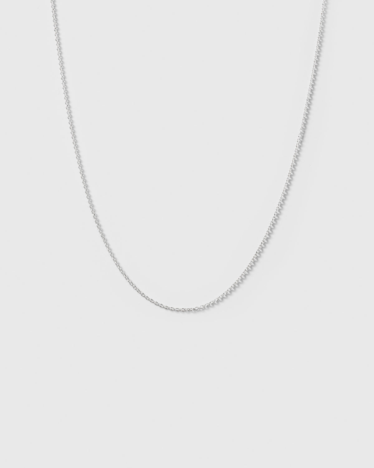 A product shot of the Beloved Short Oval Chain in silver, showcasing its fine anchor chain design.