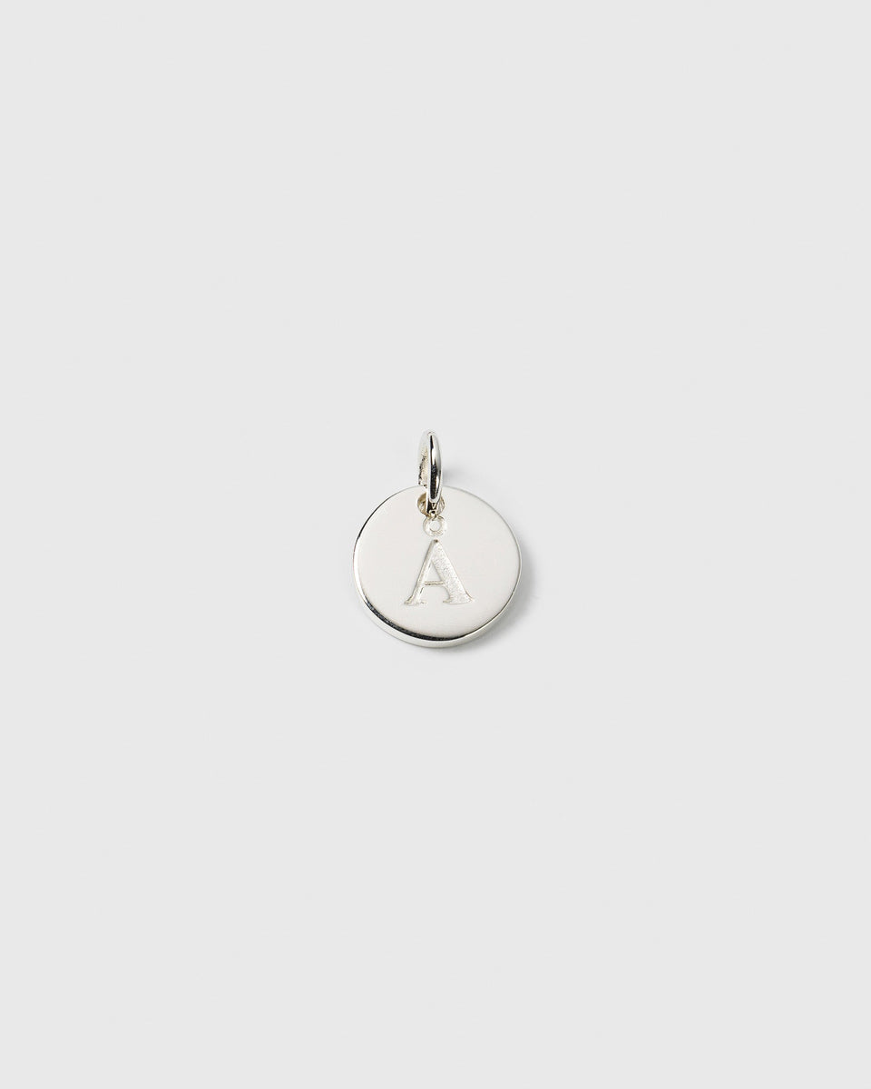 A close-up product shot of the Beloved Mini Letter pendant in silver, featuring the letter 'A' engraved on the round charm.