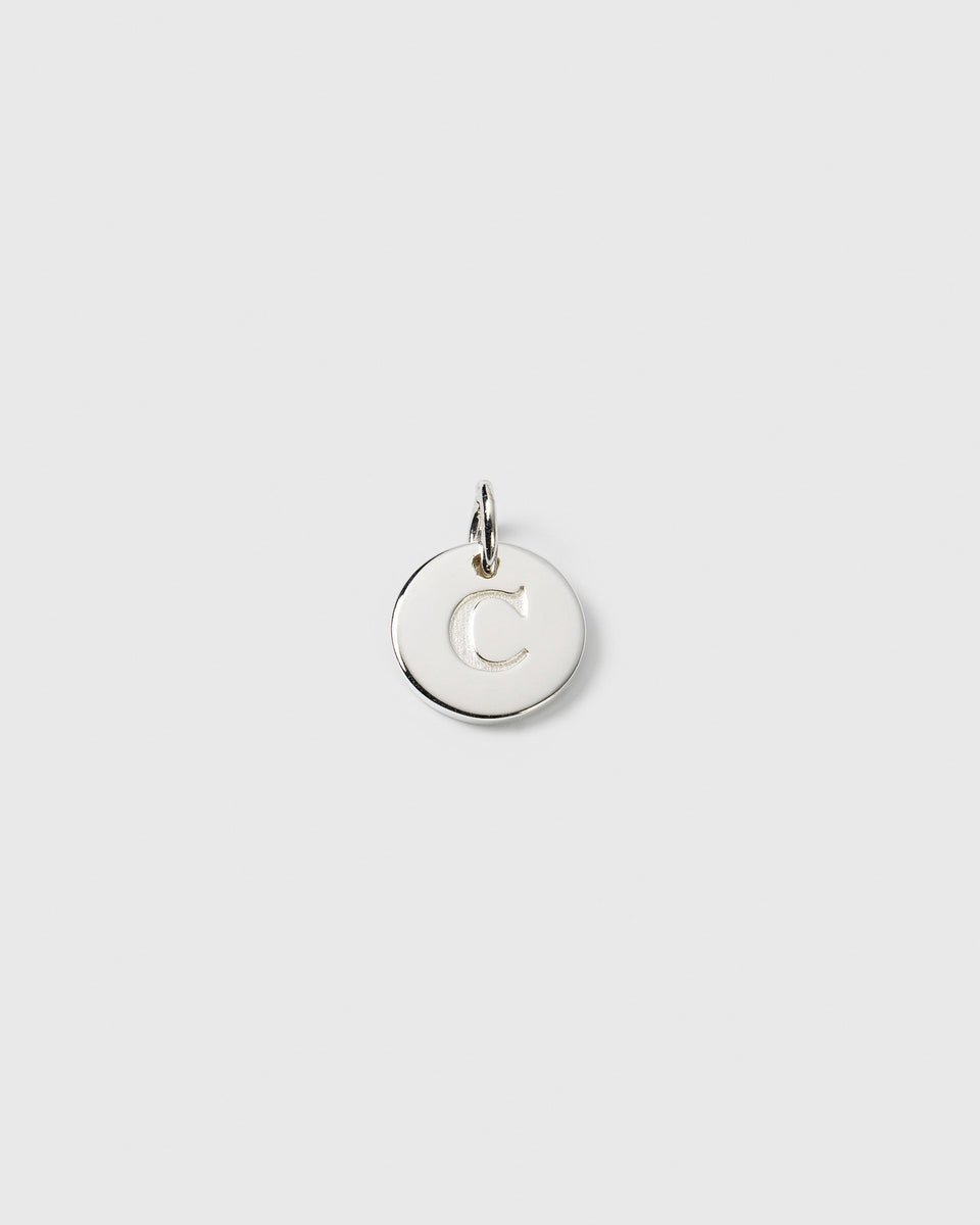 A product shot of the Beloved Mini Letter charm in silver, featuring a round pendant with the letter 'C' engraved on it.
