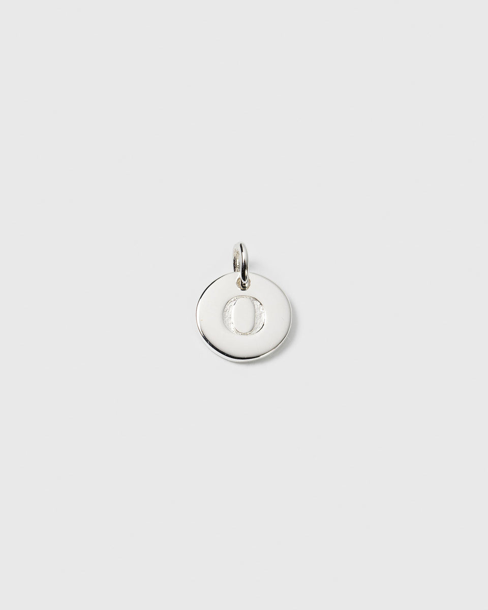 A product shot of the Syster P Beloved Mini Letter charm in silver, featuring the letter 'O' on a small, round pendant.