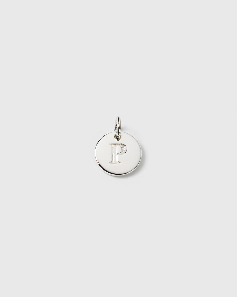 A product shot of the Beloved Mini Letter charm in silver, showing a circular pendant with the letter 'P' engraved in the center.