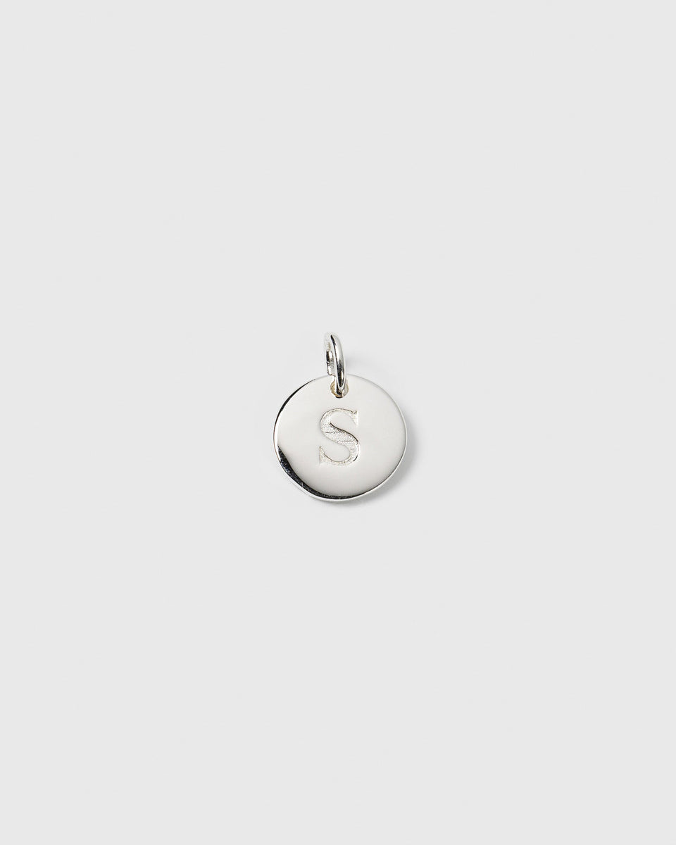 A product shot of the Beloved Mini Letter Silver pendant, showing the round silver charm engraved with the letter 'S'.